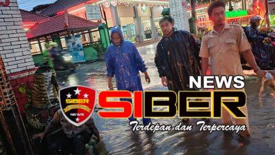 Jajaran Polsek Glenmore Sigap Atur Lalu Lintas Akibat Genangan Air di Jalan Raya Nasional